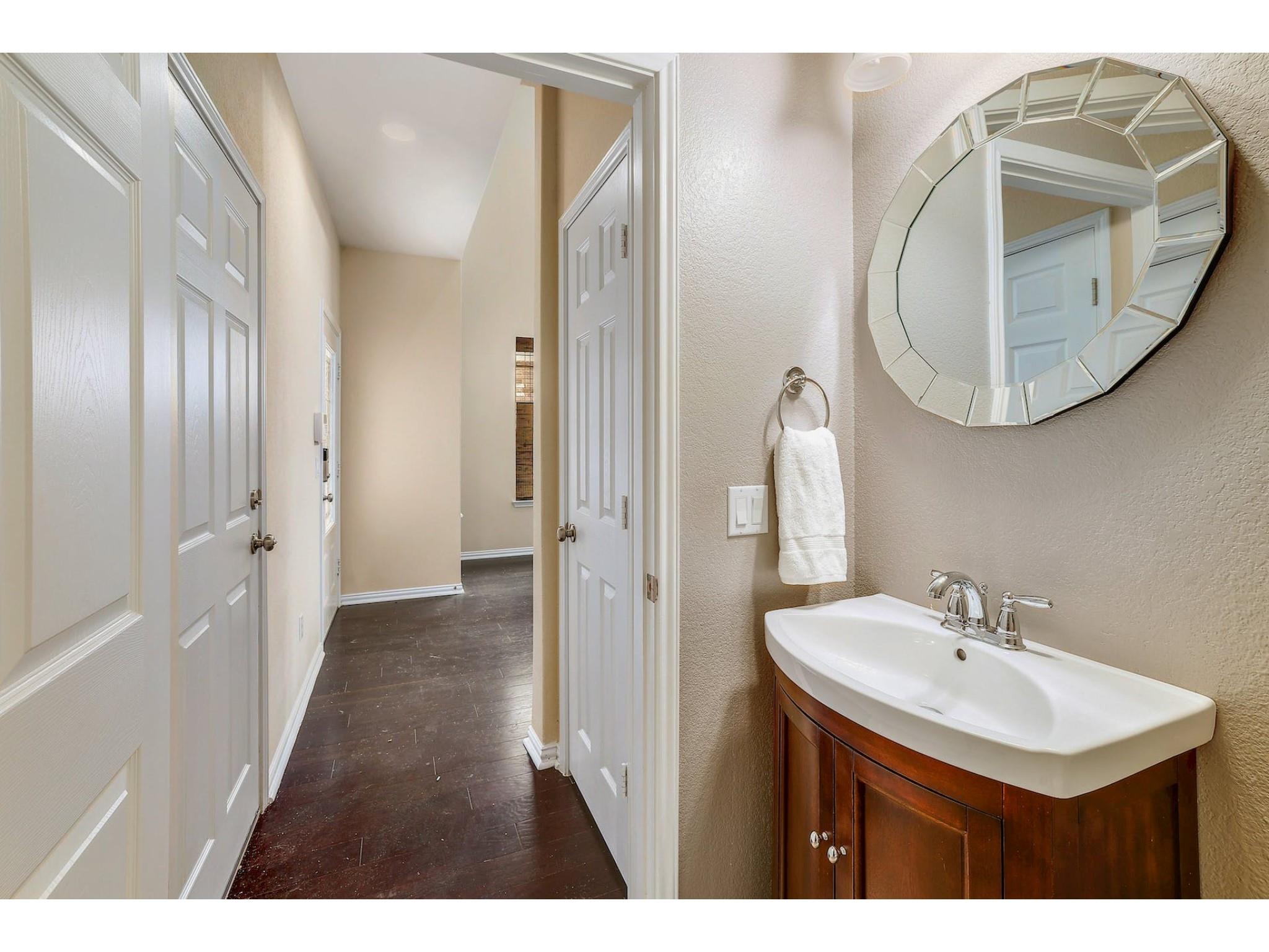 16021 Travesia Way Austin, TX 78728 - Photo 22 of 27 a bathroom with a sink and a mirror