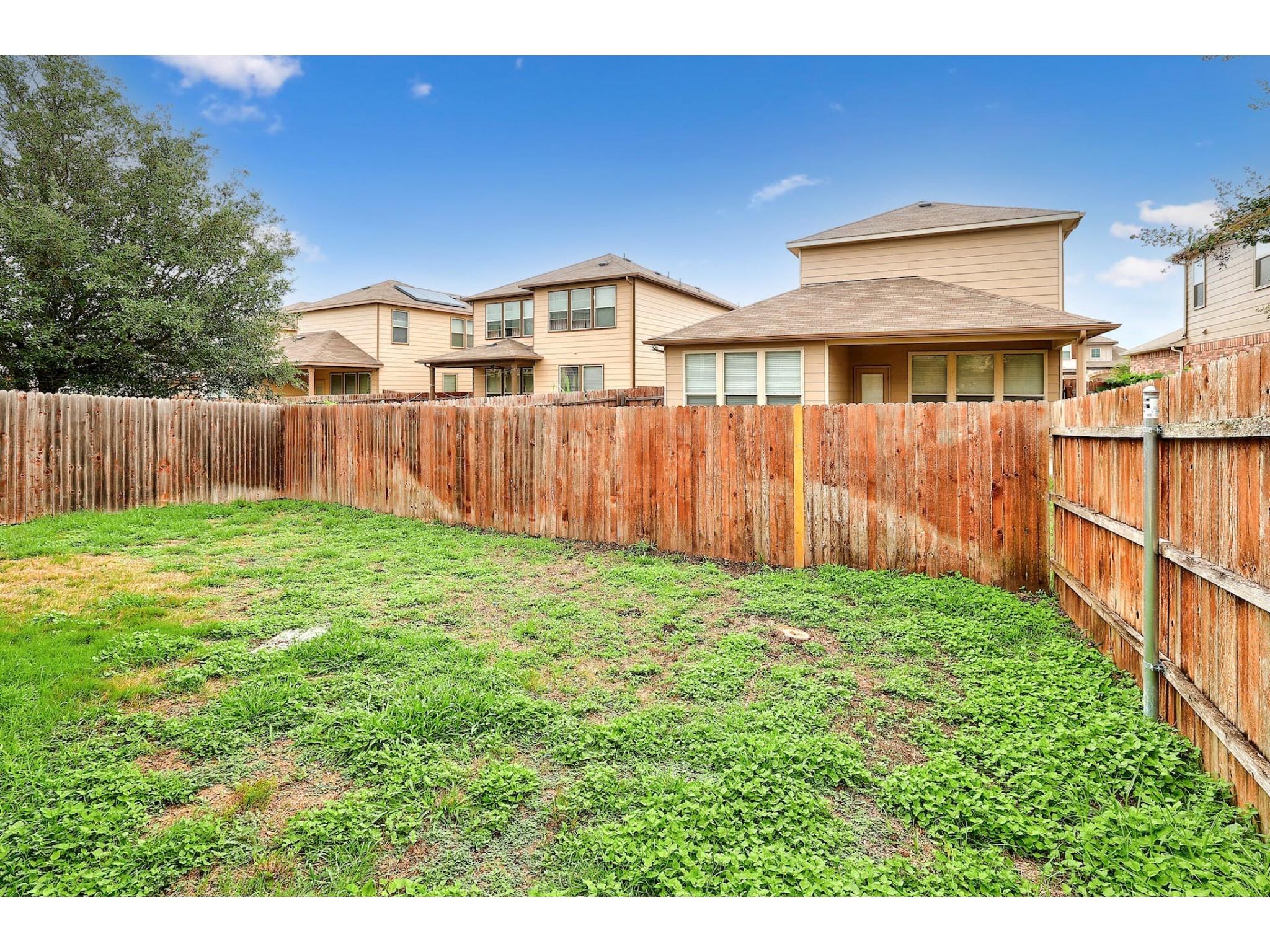 16021 Travesia Way Austin, TX 78728 - Photo 26 of 27 a view of backyard of house with wooden fence