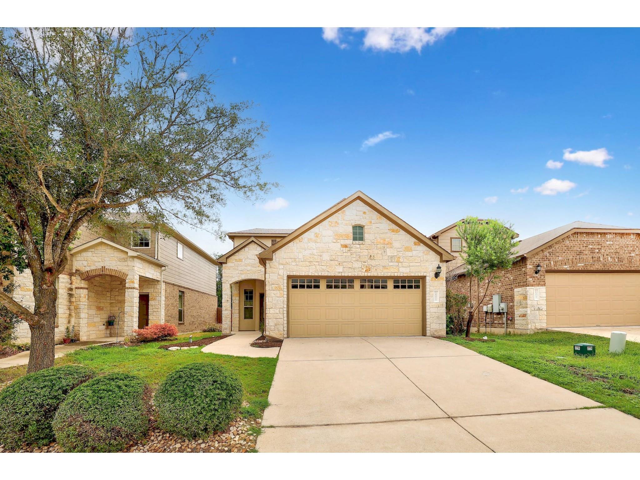 16021 Travesia Way Austin, TX 78728 - Photo 3 of 27 a front view of a house with a yard and garage