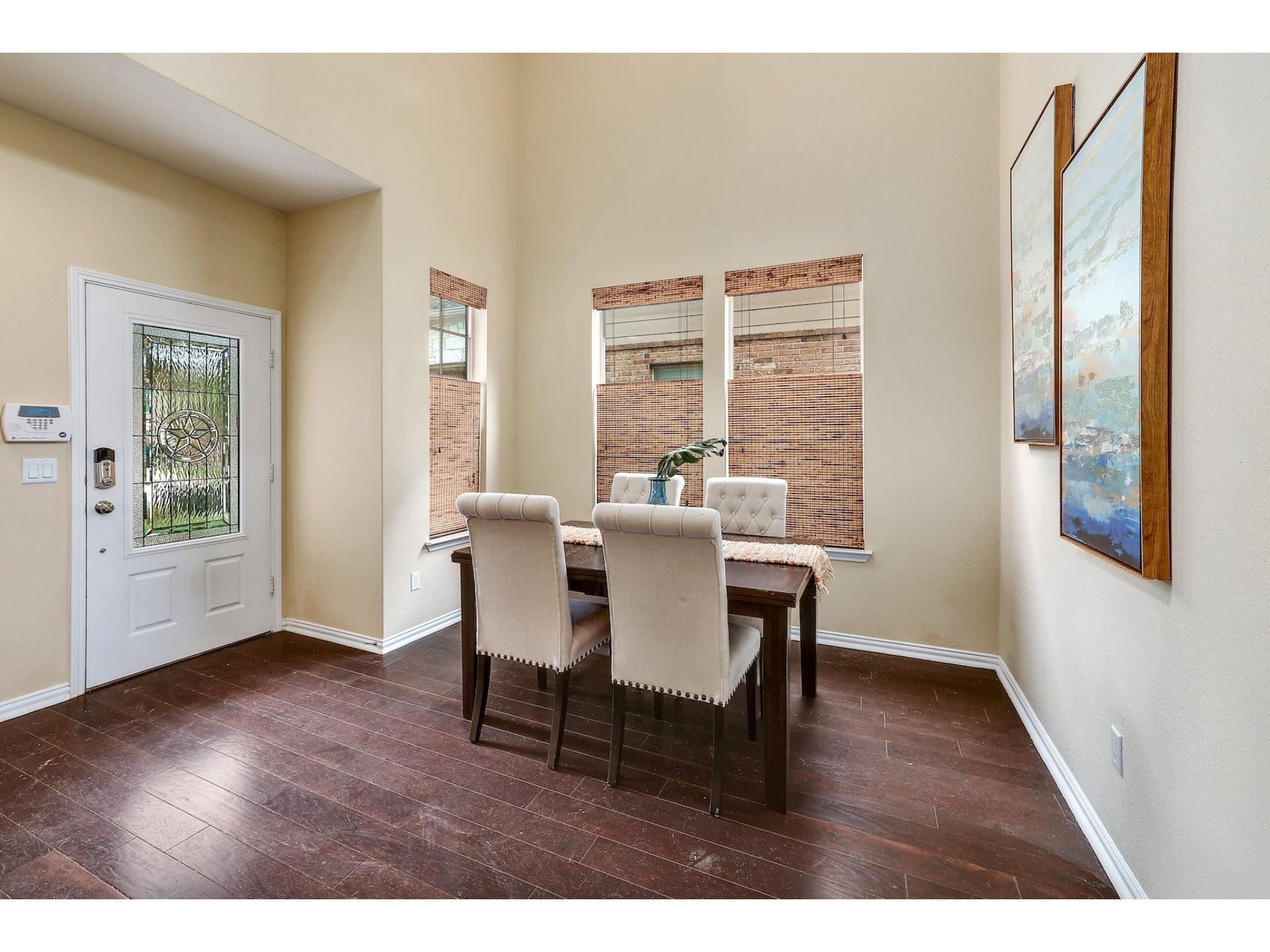 16021 Travesia Way Austin, TX 78728 - Photo 5 of 27 a view of a dining room with furniture window and wooden floor