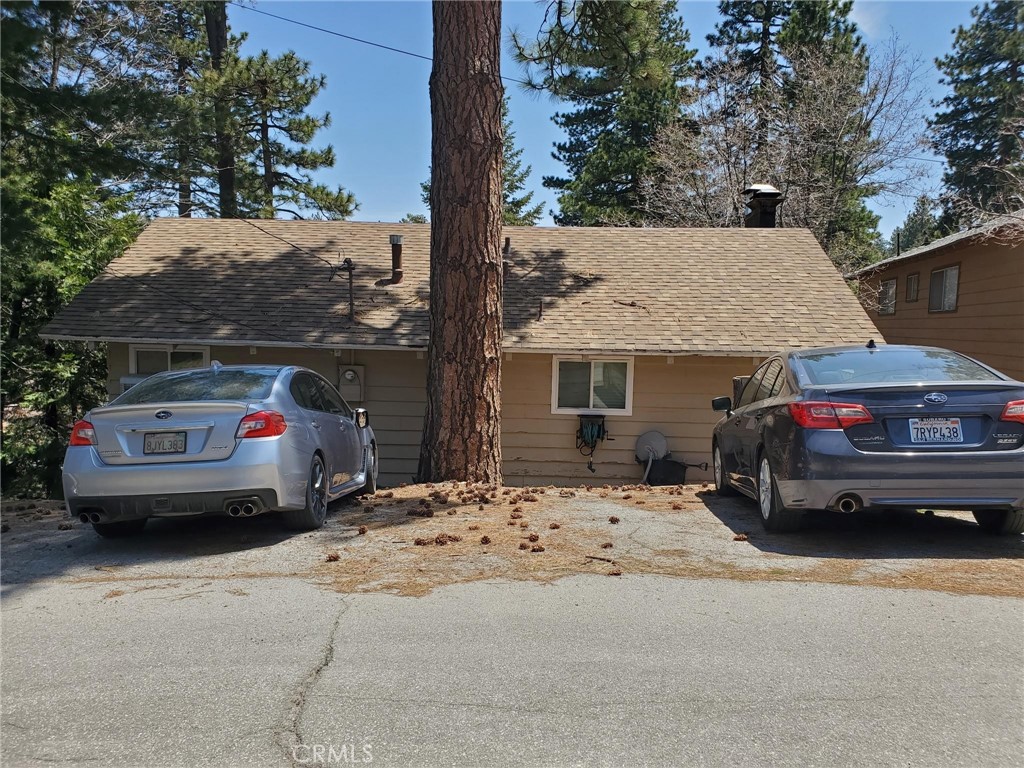 a view of parking space in front of a house
