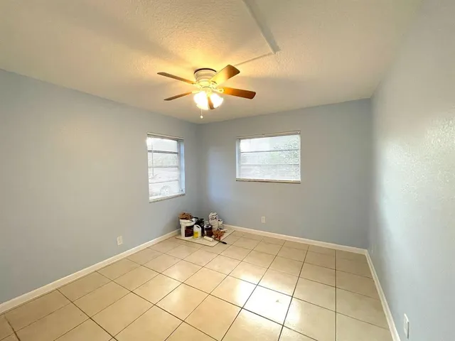 a view of room with window and ceiling fan