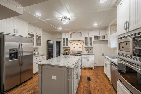 a kitchen with a refrigerator stove and sink