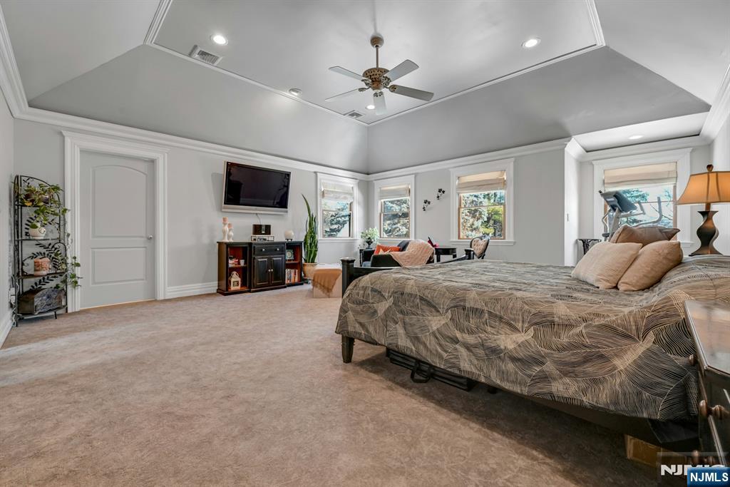 285 Chestnut Ridge Road Woodcliff Lake, NJ 07677 - Photo 35 of 46 a spacious bedroom with a bed and a flat screen tv