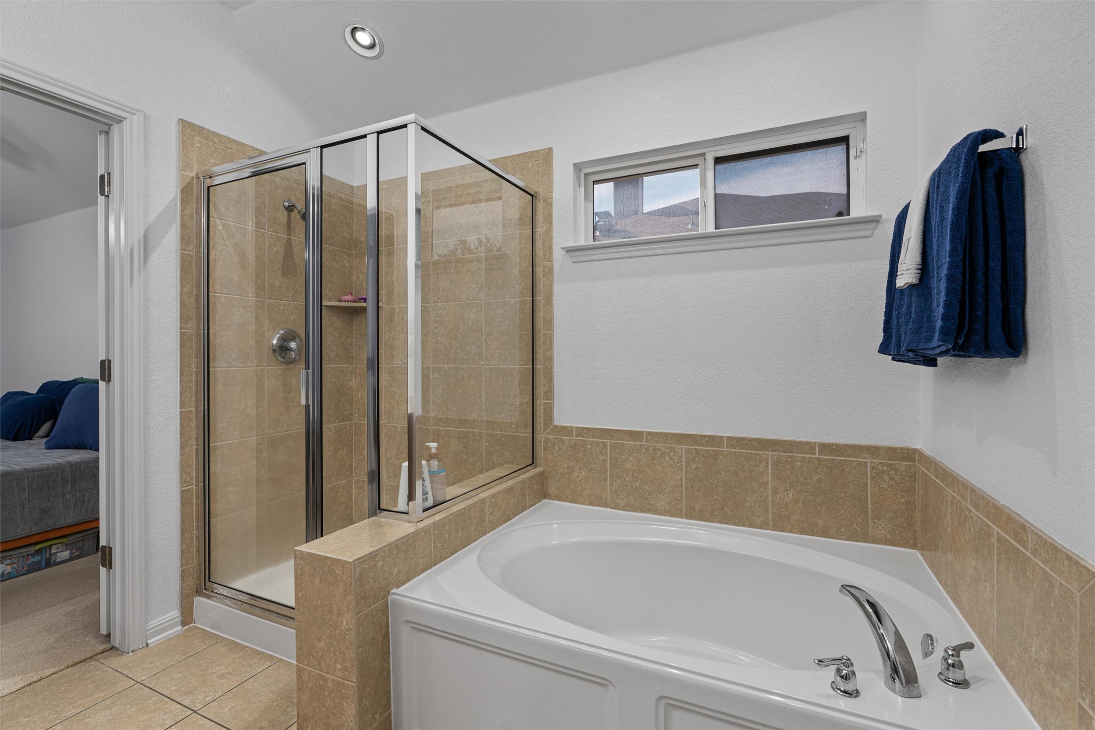 20513 Jackies Ranch Boulevard Pflugerville, TX 78660 - Photo 14 of 35 a bathroom with a tub and a shower