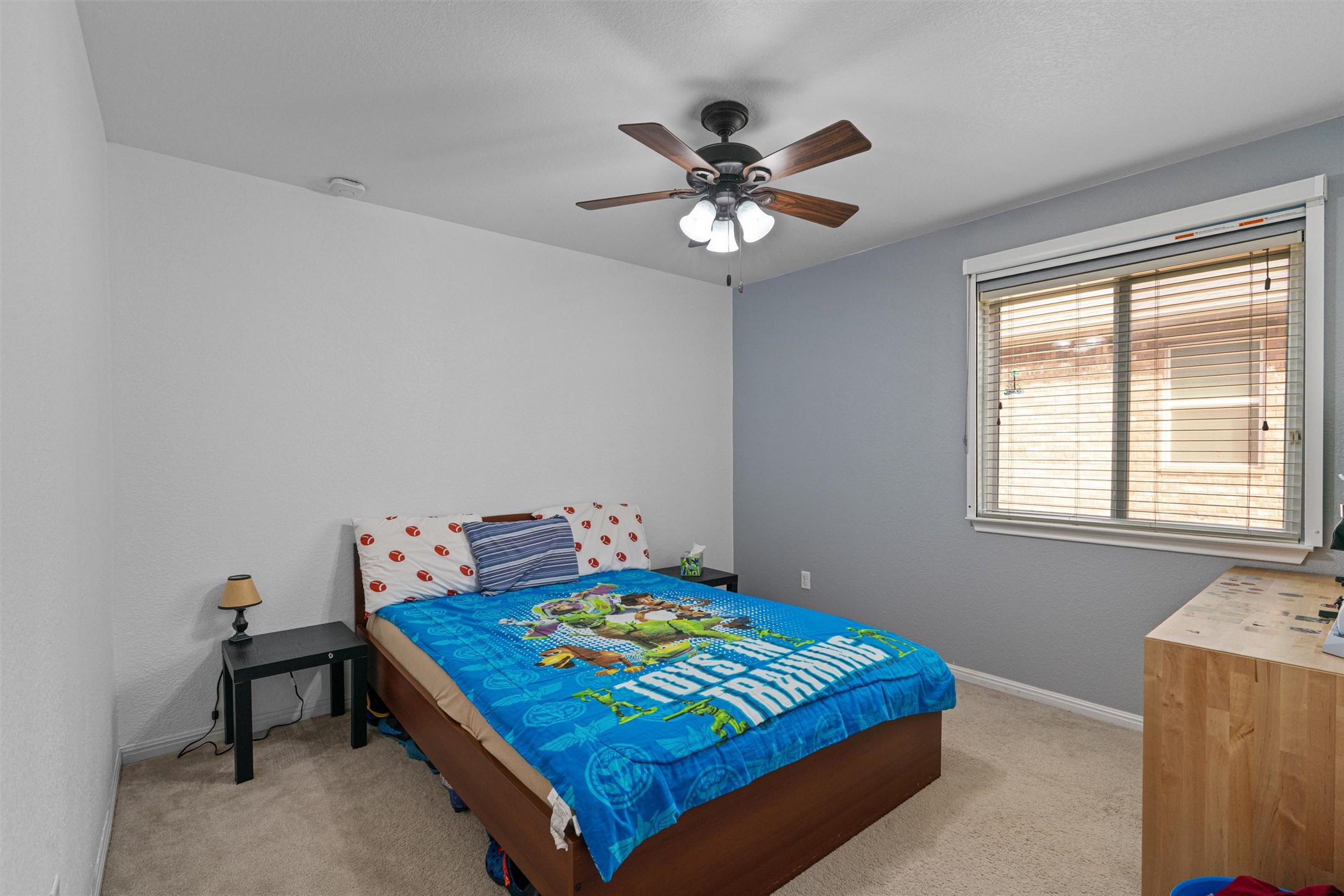 20513 Jackies Ranch Boulevard Pflugerville, TX 78660 - Photo 17 of 35 a bedroom with a bed and a chandelier