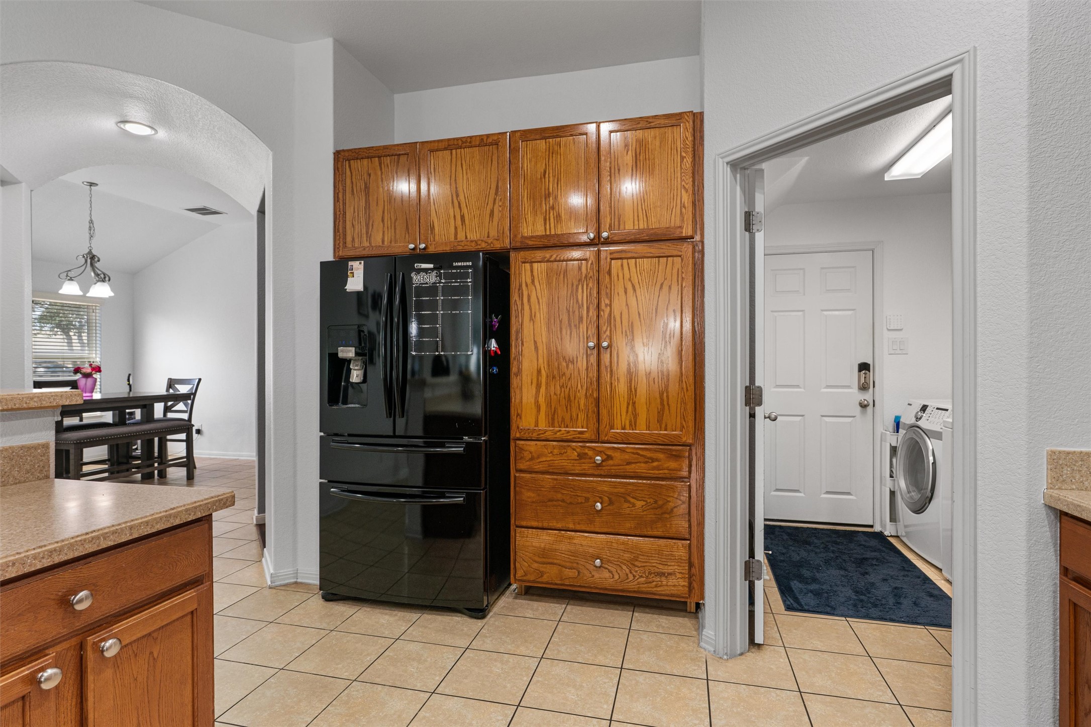 20513 Jackies Ranch Boulevard Pflugerville, TX 78660 - Photo 4 of 35 a kitchen with stainless steel appliances granite countertop a refrigerator and cabinets