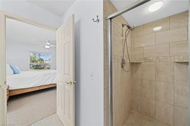 a bathroom with a double vanity sink and shower