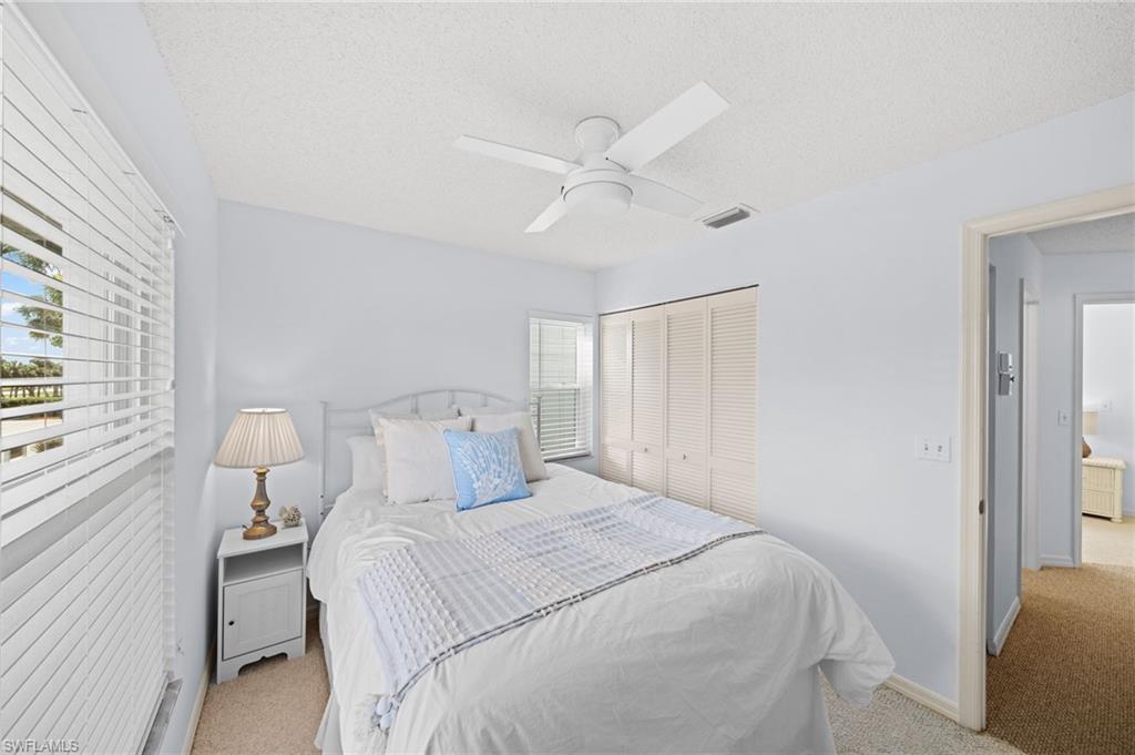 121 Wading Bird Circle, Unit B201 Naples, FL 34110 - Photo 26 of 33 a bedroom with a bed and a window