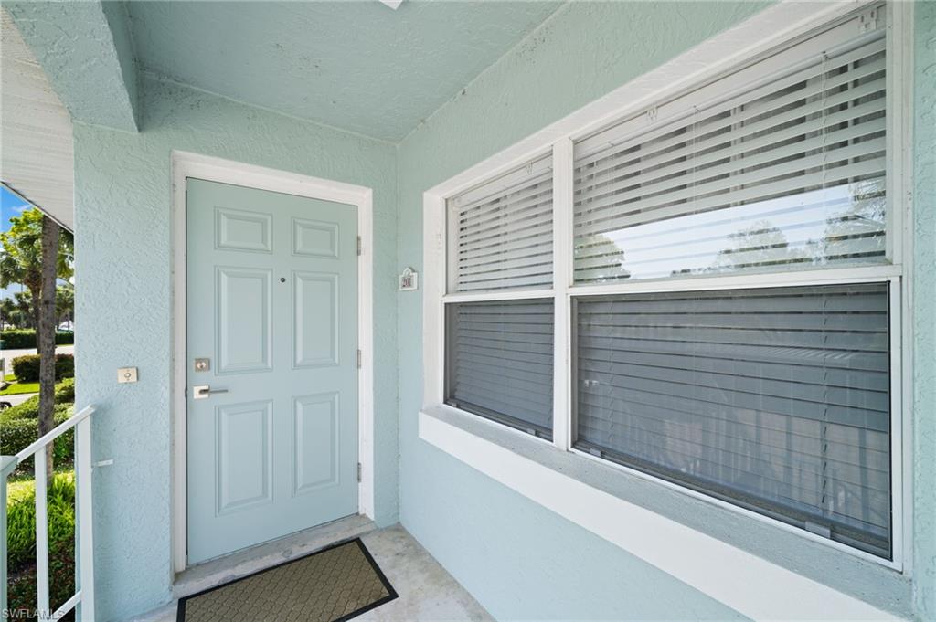 121 Wading Bird Circle, Unit B201 Naples, FL 34110 - Photo 30 of 33 a view of a balcony a door
