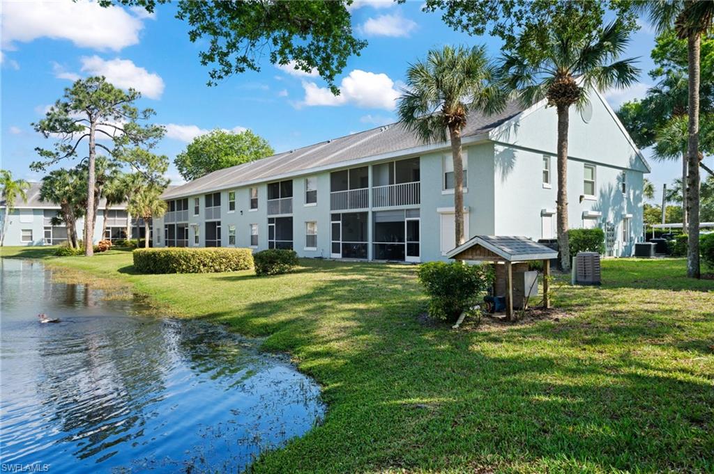 121 Wading Bird Circle, Unit B201 Naples, FL 34110 - Photo 32 of 33 a view of a house with backyard and sitting area