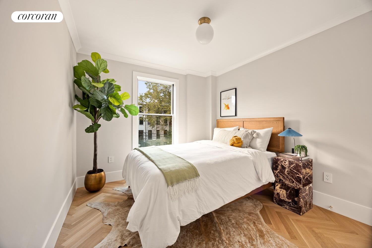 95 Monroe Street Brooklyn, NY 11216 - Photo 10 of 21 a bedroom with a bed and a window