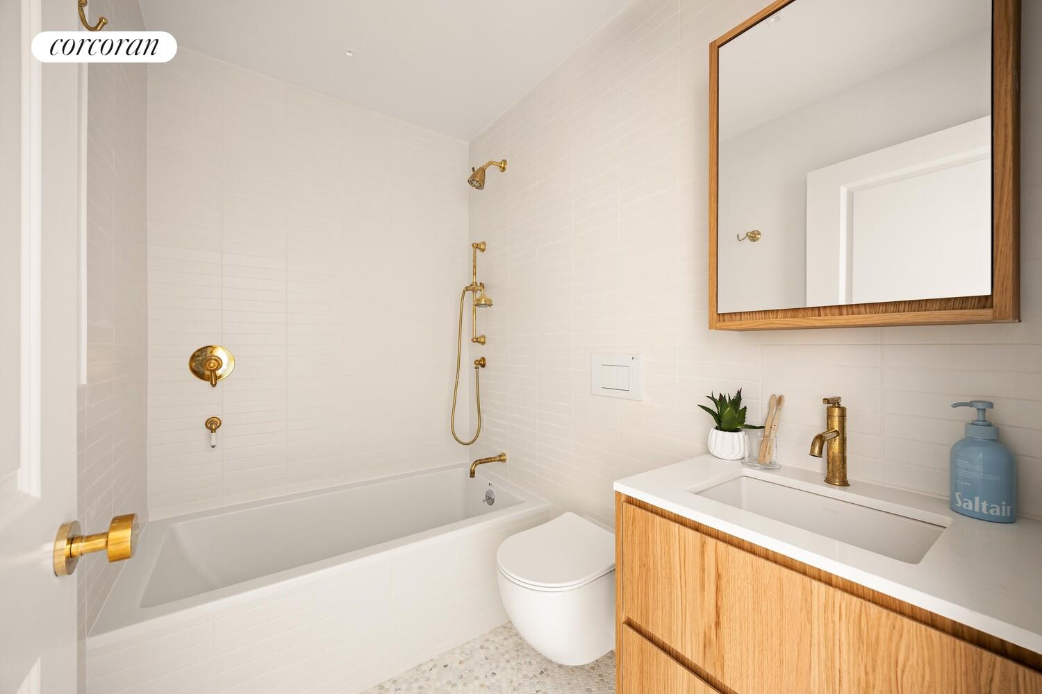 95 Monroe Street Brooklyn, NY 11216 - Photo 11 of 21 a bathroom with a sink a toilet and shower