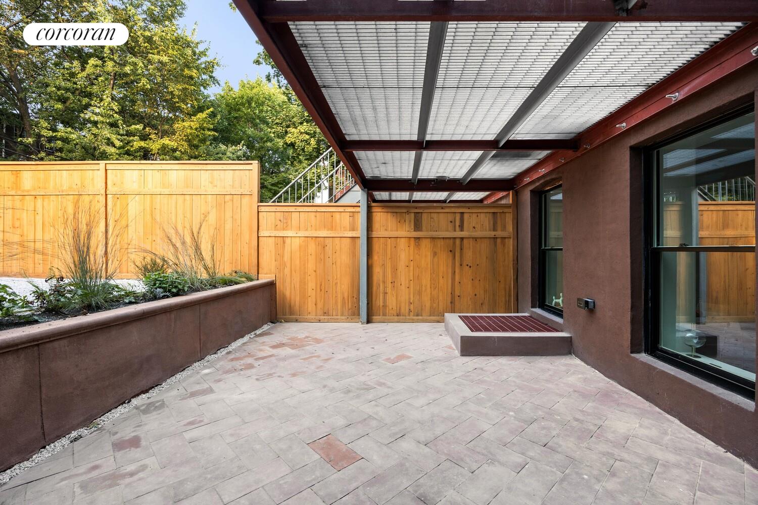 95 Monroe Street Brooklyn, NY 11216 - Photo 17 of 21 a view of porch with a table and chairs