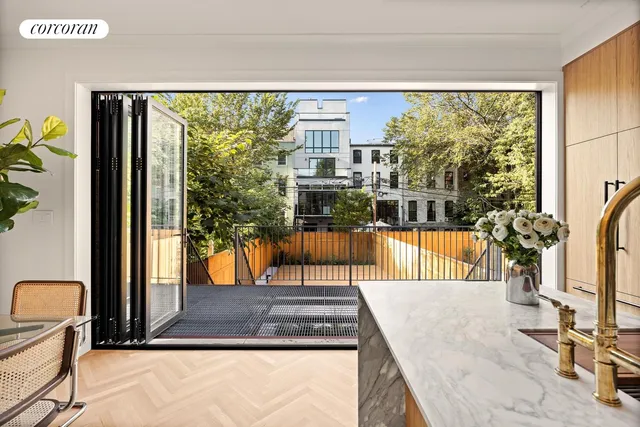 a kitchen with stainless steel appliances granite countertop a sink window and cabinets