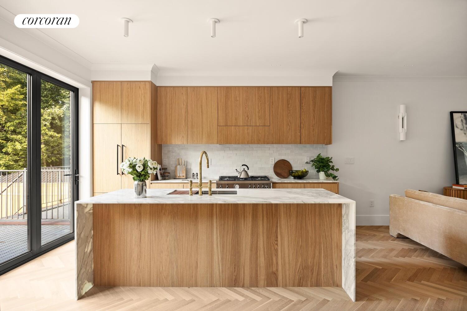 95 Monroe Street Brooklyn, NY 11216 - Photo 5 of 21 a kitchen with stainless steel appliances granite countertop a sink window and cabinets