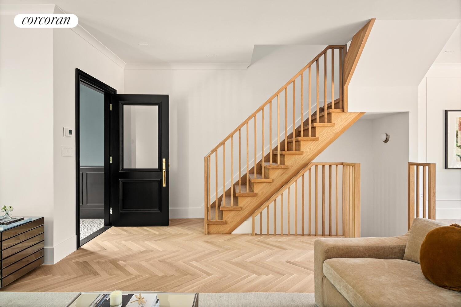 95 Monroe Street Brooklyn, NY 11216 - Photo 7 of 21 a view of livingroom with wooden floor and stairs