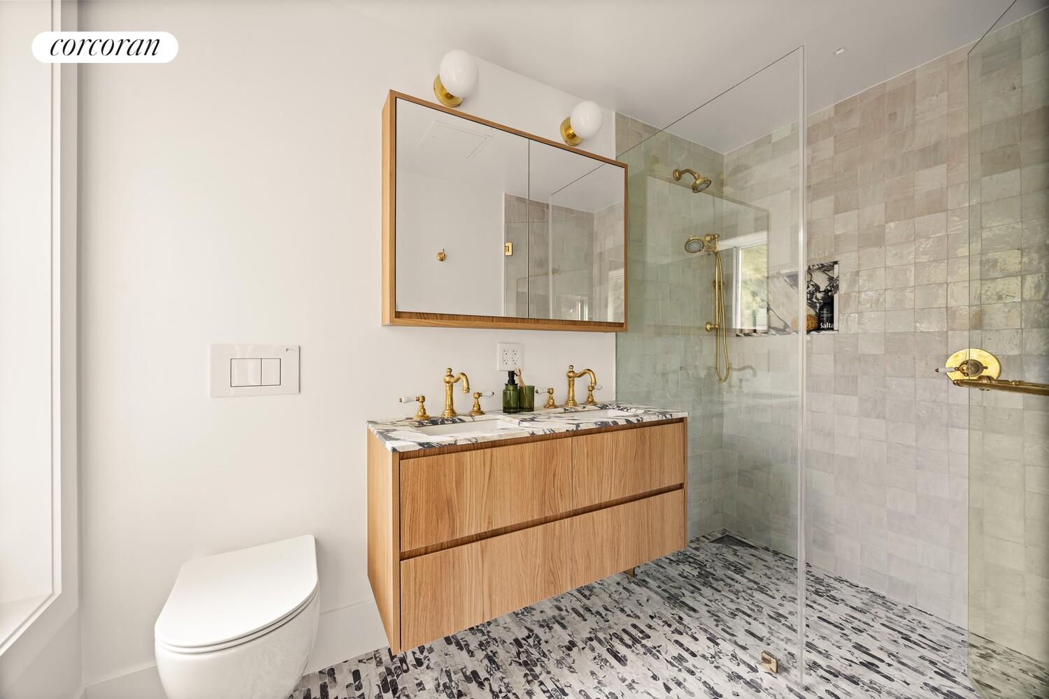 95 Monroe Street Brooklyn, NY 11216 - Photo 9 of 21 a bathroom with a toilet a sink and mirror