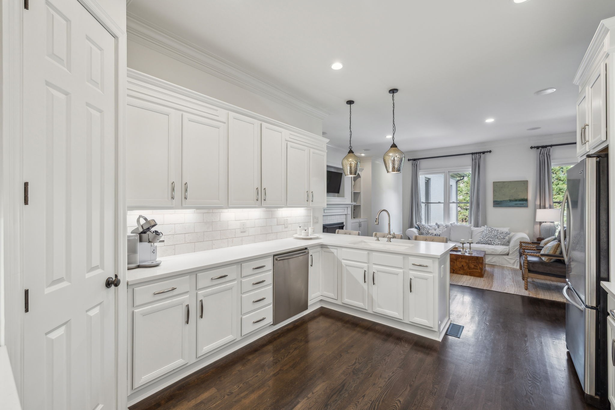 424 Wild Elm Street Franklin, TN 37064 - Photo 15 of 100 a large white kitchen with a large window a sink and stainless steel appliances