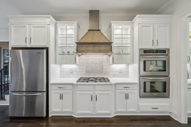 a bed sitting in a spacious bedroom next to a window