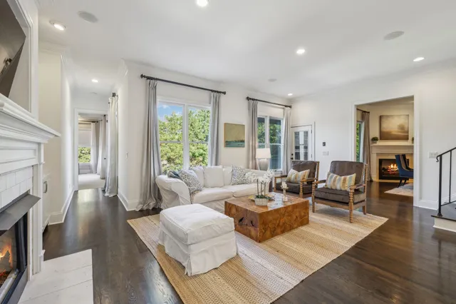 a living room with a fireplace and a floor to ceiling window
