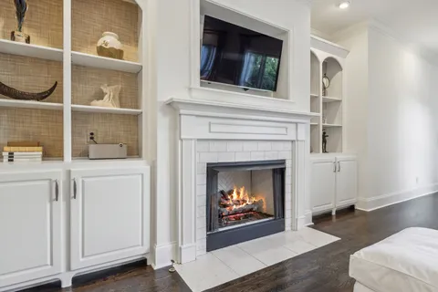 a spacious bedroom with a bed a window and a chandelier