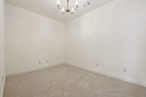 a view of a house with backyard water fountain and sitting area