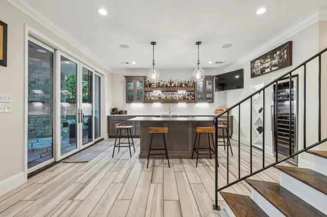 a backyard of a house with barbeque oven fire pit table and chairs