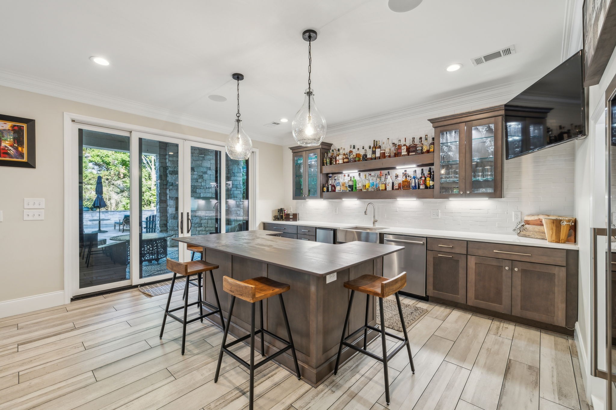 424 Wild Elm Street Franklin, TN 37064 - Photo 49 of 100 a kitchen with stainless steel appliances granite countertop table chairs stove and wooden floor