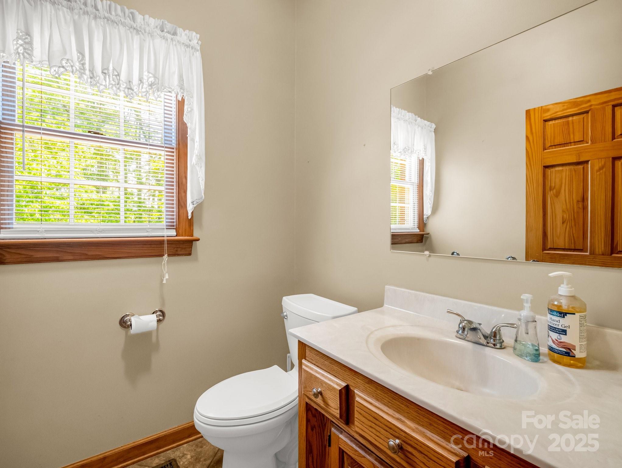 163 Summit Lane Rutherfordton, NC 28139 - Photo 14 of 44 a bathroom with a granite countertop sink a toilet and a mirror