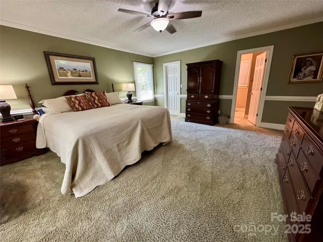 a spacious bedroom with a bed and a walk in closet