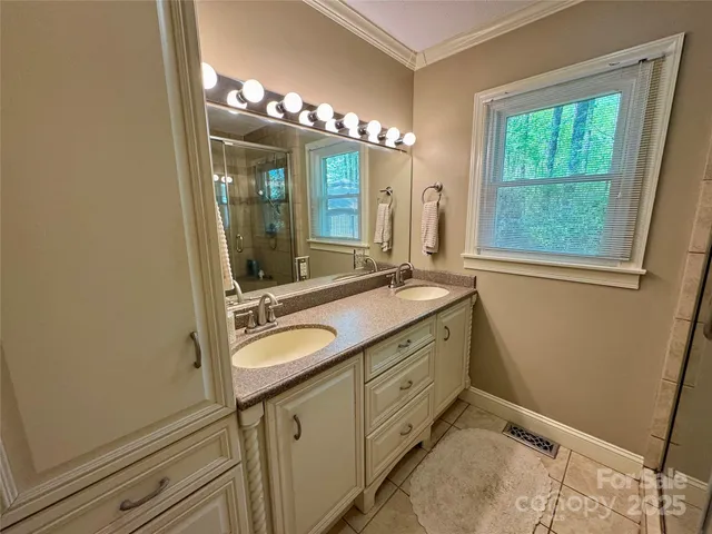 a bathroom with a double vanity sink and a mirror