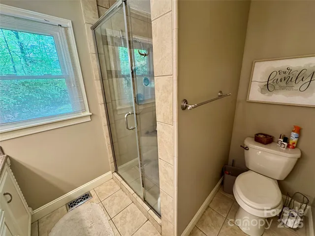 a bathroom with a toilet and a shower