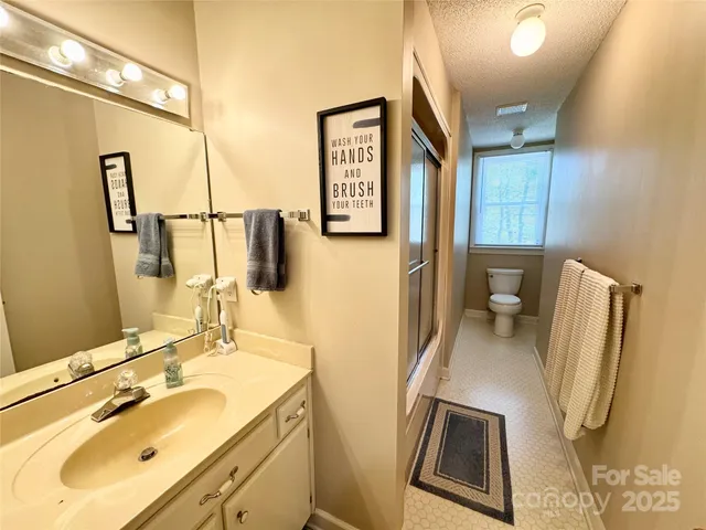 a bathroom with a sink toilet and mirror