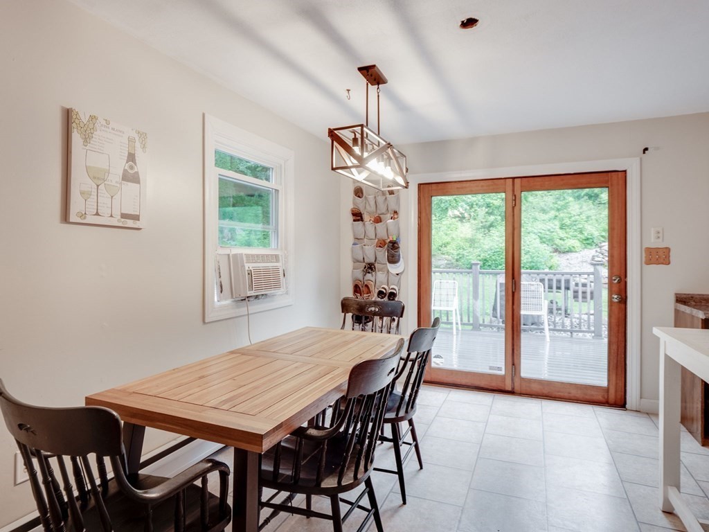 1850 North Brookfield Road Oakham, MA 01068 - Photo 29 of 42 a dining room with wooden floor a chandelier a wooden table and chairs