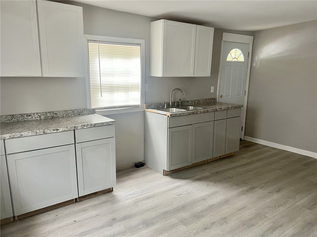 301 Hammett Street Honea Path, SC 29654 - Photo 4 of 14 This newly renovated kitchen area boasts ample counter space and fresh cabinetry, creating a pristine culinary environment.