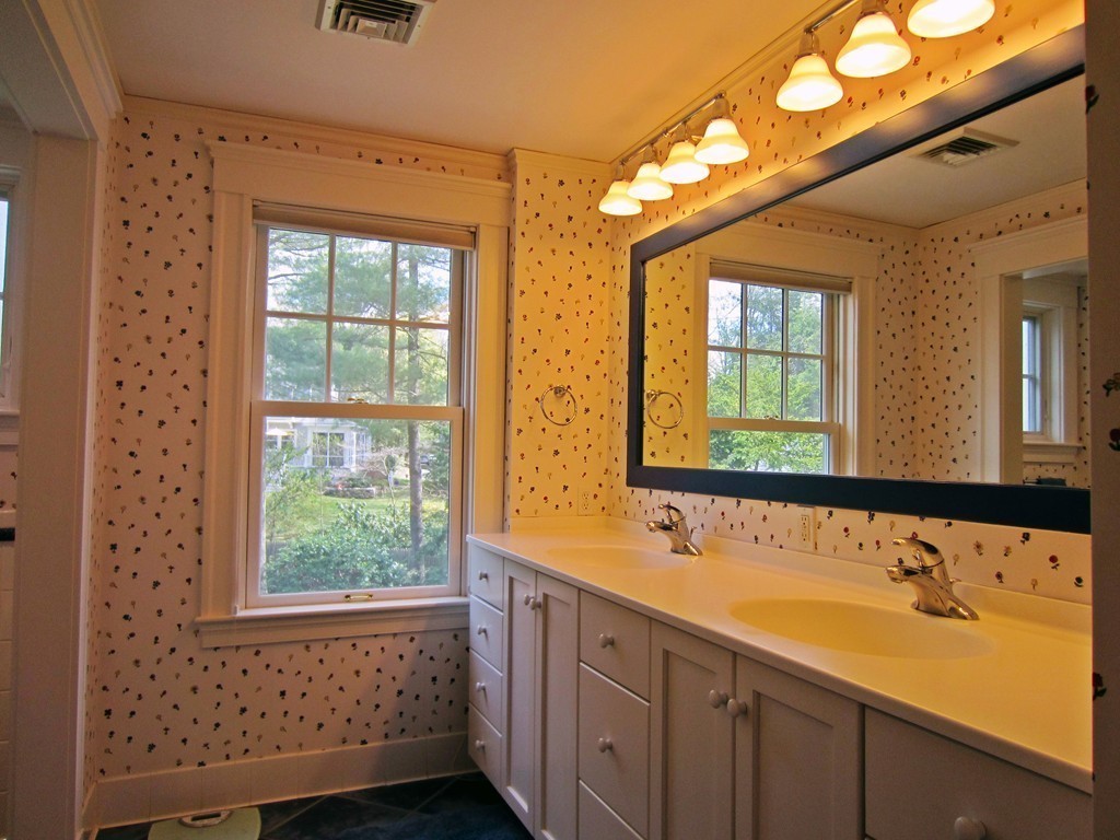 12 Arlington Road Wellesley, MA 02481 - Photo 20 of 26 a bathroom with a double vanity sink a mirror and a bathtub