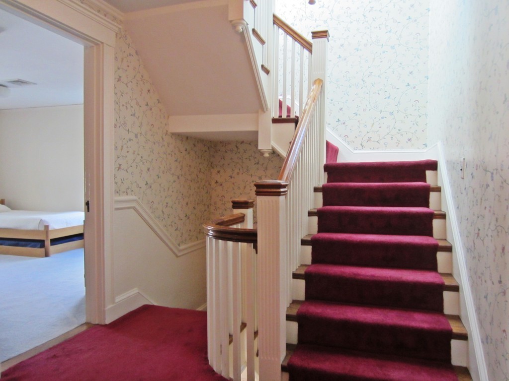 12 Arlington Road Wellesley, MA 02481 - Photo 5 of 26 a view of entryway with wooden floor and stairs