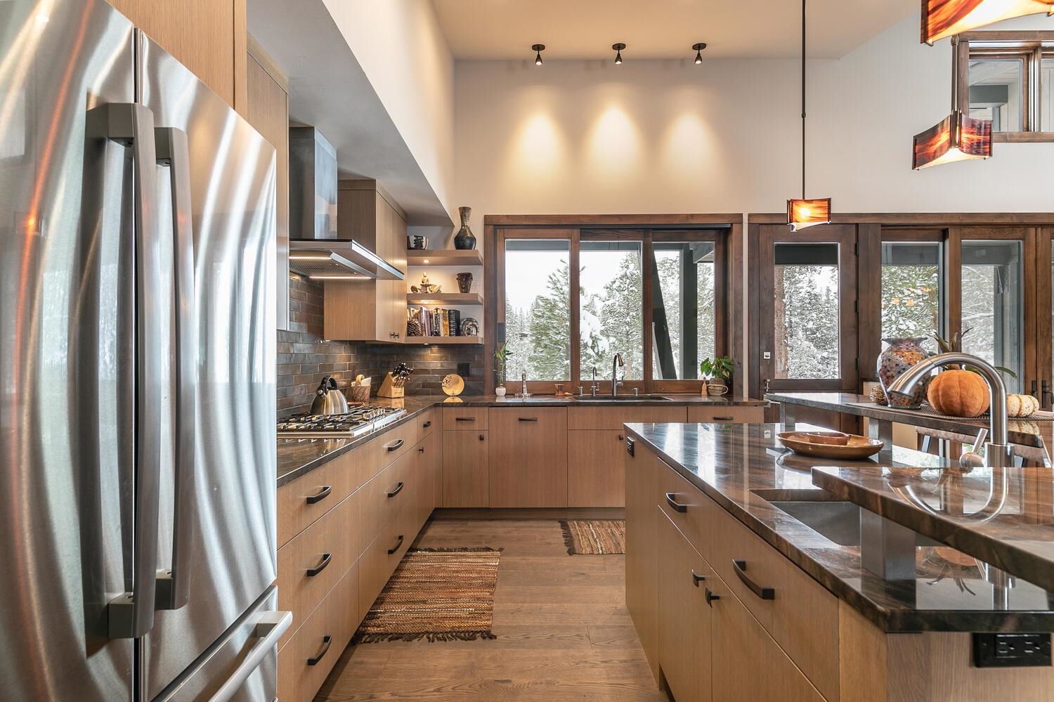 11631 Ghirard Road Truckee, CA 96161 - Photo 9 of 21 a kitchen with stainless steel appliances granite countertop a refrigerator a sink dishwasher a stove and a dining table next to a window