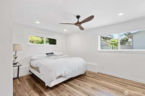 a bedroom with a bed and a painting on the wall