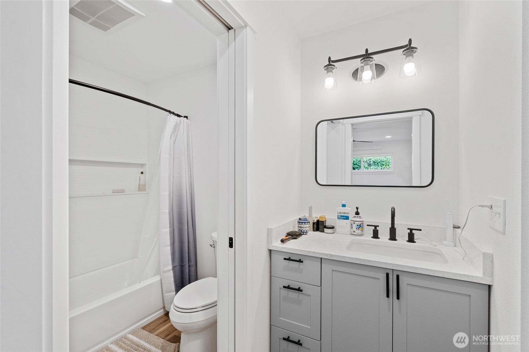 201 South State Street, Unit A Bellingham, WA 98225 - Photo 16 of 35 a bathroom with a toilet sink and mirror