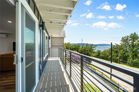 a view of balcony with wooden floor and fence