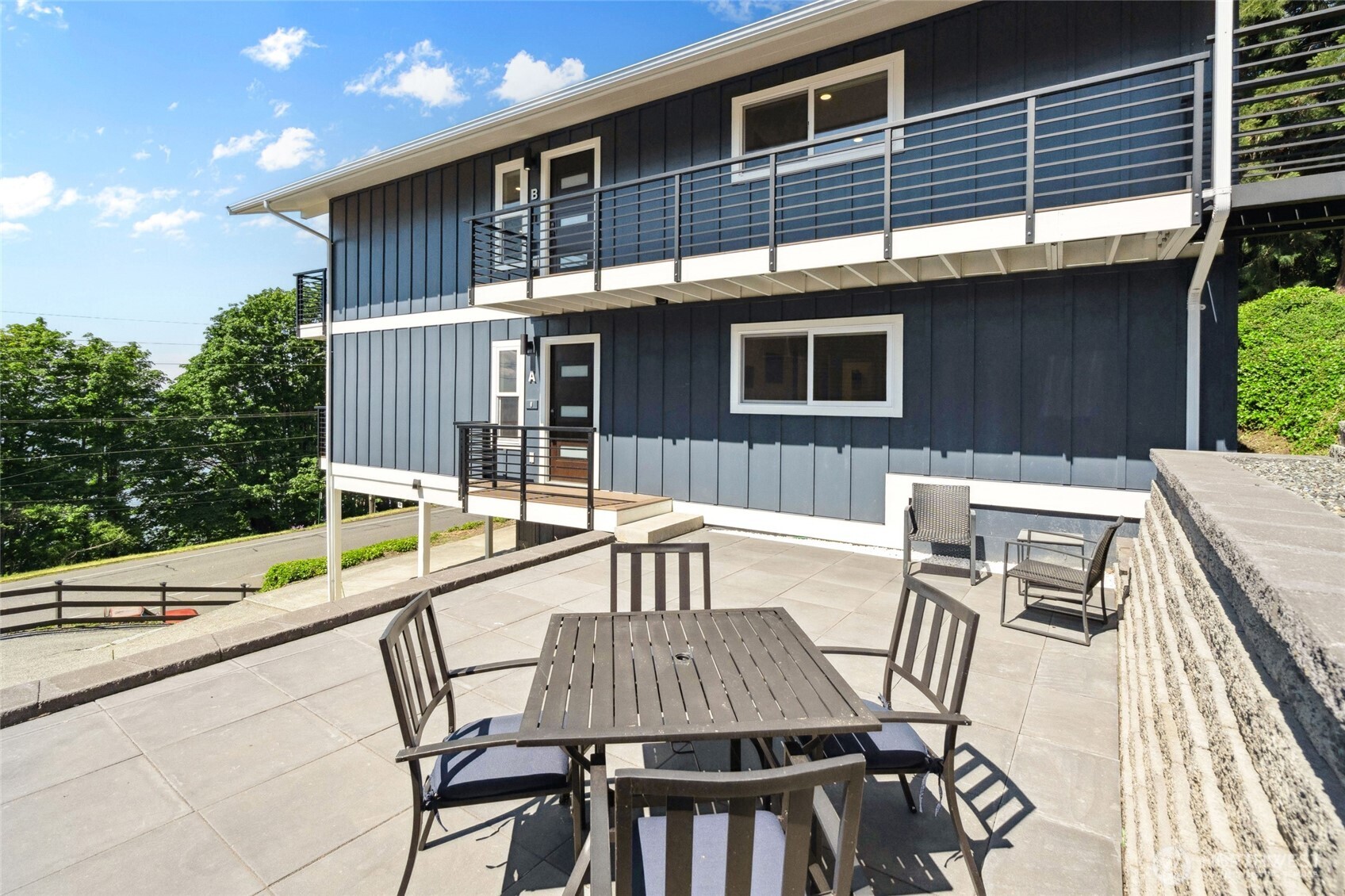 201 South State Street, Unit A Bellingham, WA 98225 - Photo 19 of 35 a view of a patio with table and chairs with wooden floor and fence