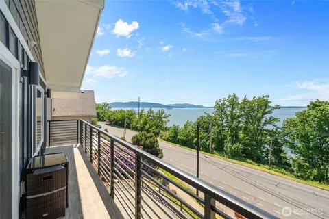 a view of balcony with wooden floor and fence