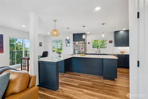 a kitchen with stainless steel appliances granite countertop a sink and a microwave
