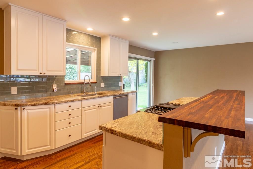 1415 Samuel Way Reno, NV 89509 - Photo 8 of 25 a open kitchen with granite countertop white cabinets and white appliances