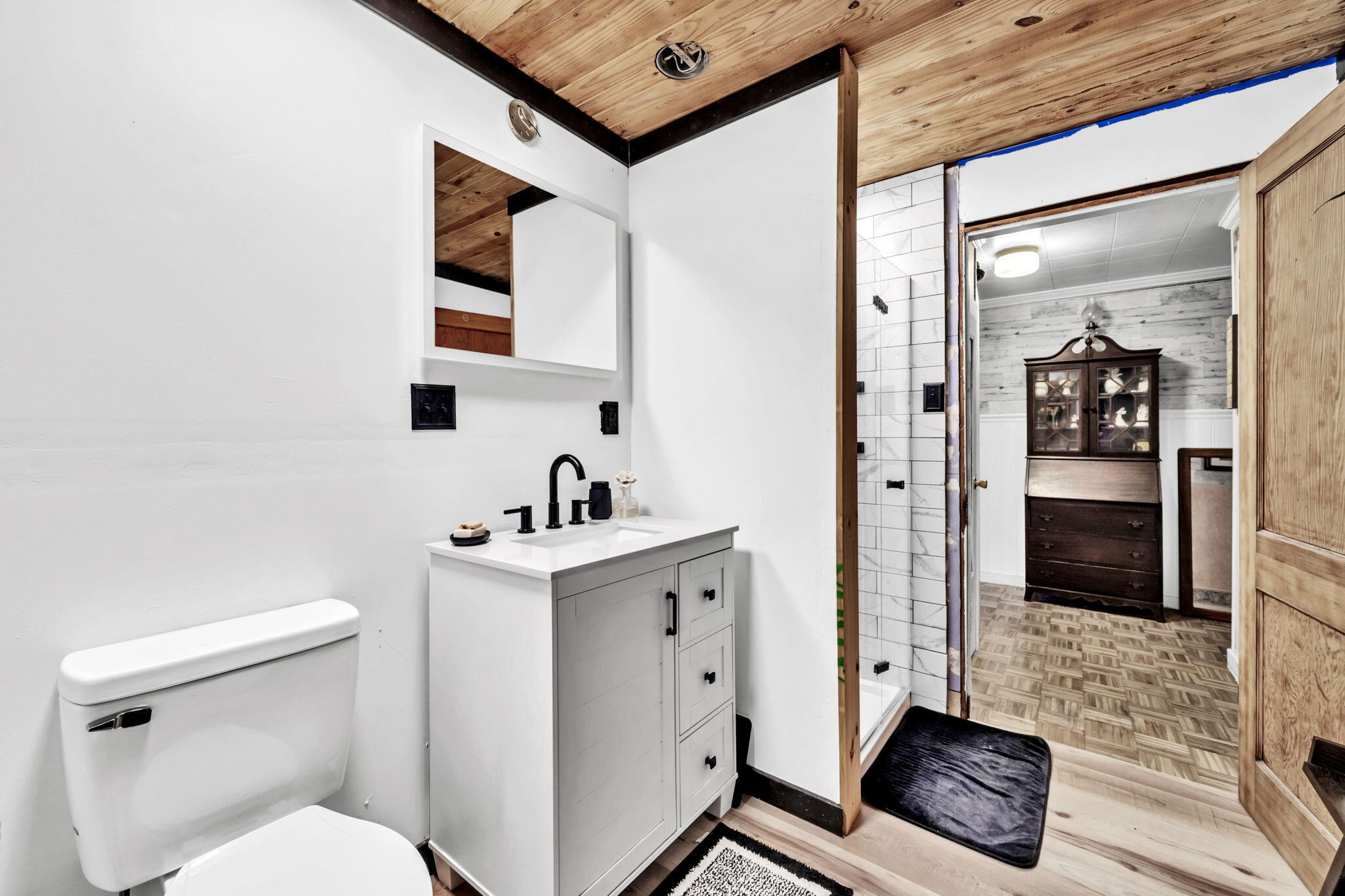 226 South 19th Street DeFuniak Springs, FL 32435 - Photo 22 of 46 a bathroom with a toilet a sink and mirror