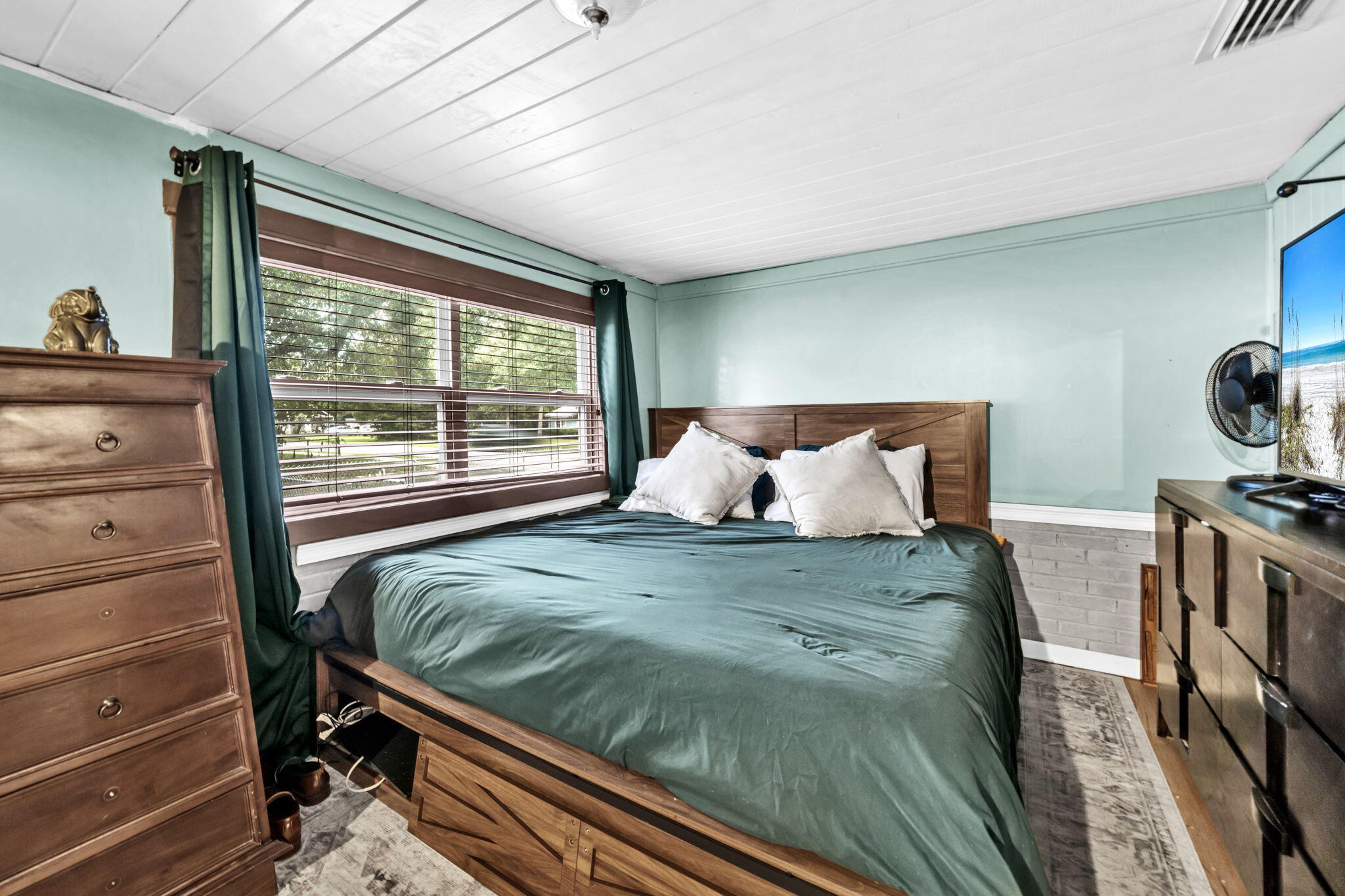 226 South 19th Street DeFuniak Springs, FL 32435 - Photo 24 of 46 a bed sitting in a bedroom next to a window