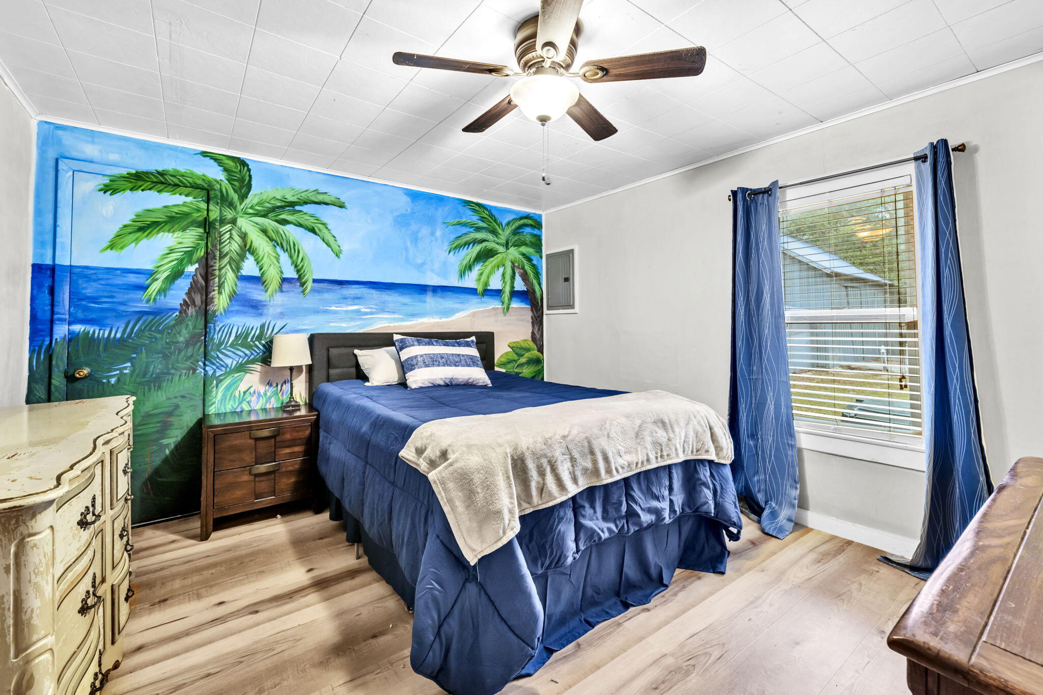 226 South 19th Street DeFuniak Springs, FL 32435 - Photo 35 of 46 a bedroom with a bed and a potted plant