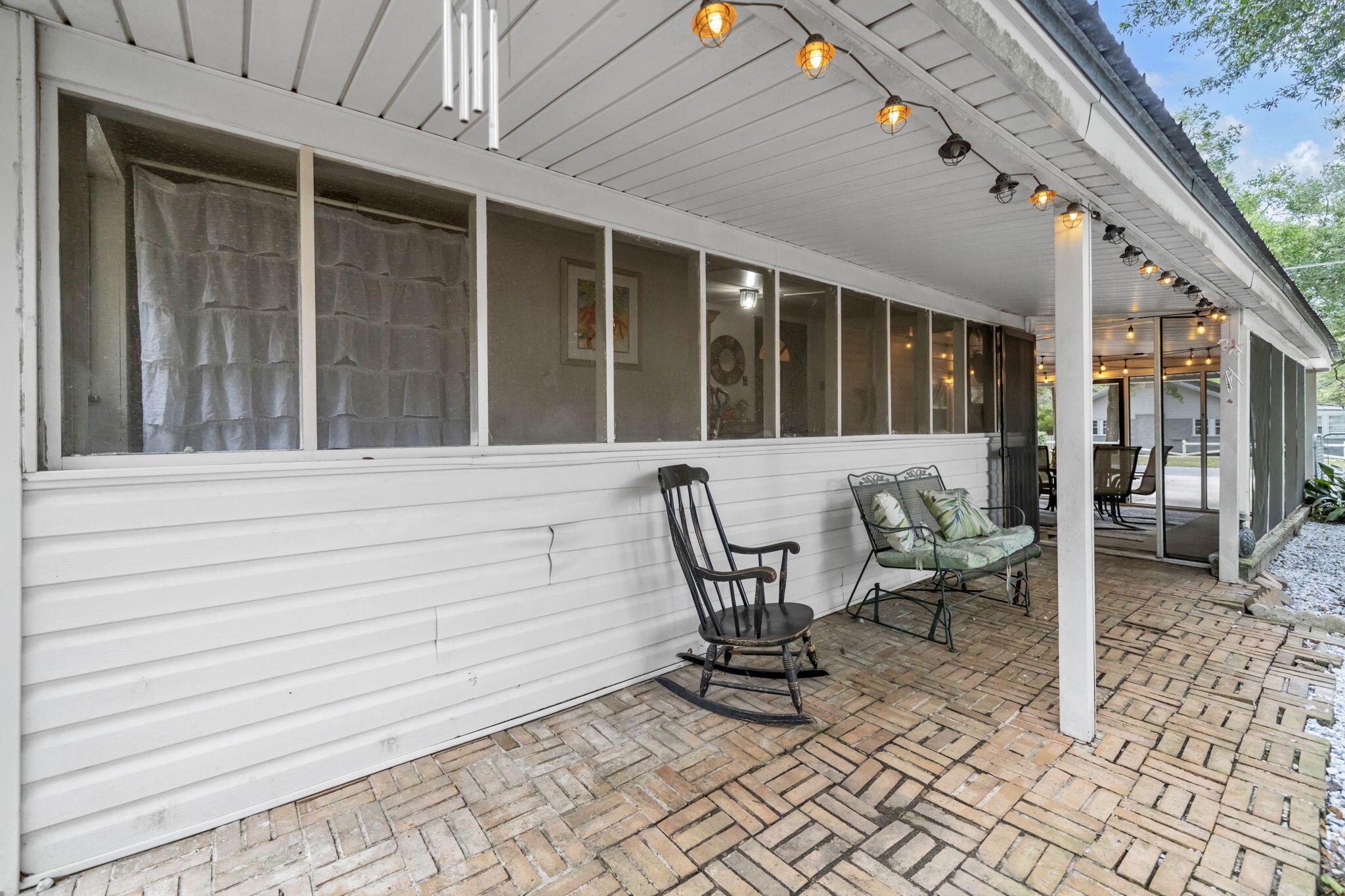 226 South 19th Street DeFuniak Springs, FL 32435 - Photo 10 of 46 a view of a patio with table and chairs and wooden floor